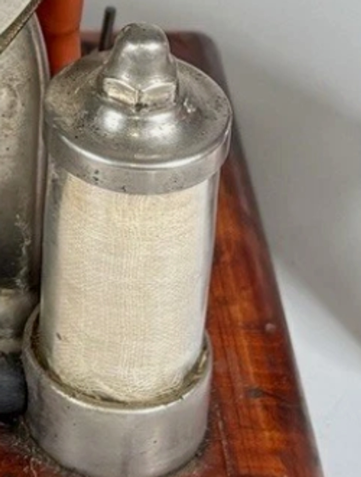 Figure 3 — One of the two "air purifiers" — a nickel-plated canister with a woven element visible through the body. The presence of fabric air filters is itself the proof that this is an air pump and not a li…