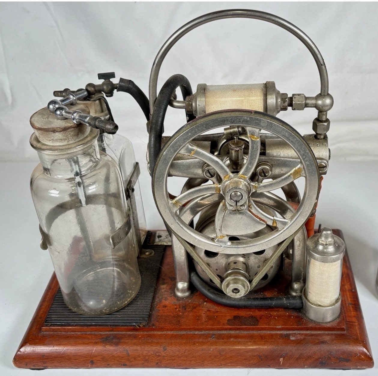 Figure 2 — The flywheel face, showing exactly the kind of surface that tempts a restorer and should be left alone. The dulling and the fine surface marking are a century of handling and storage; a buffing whe…