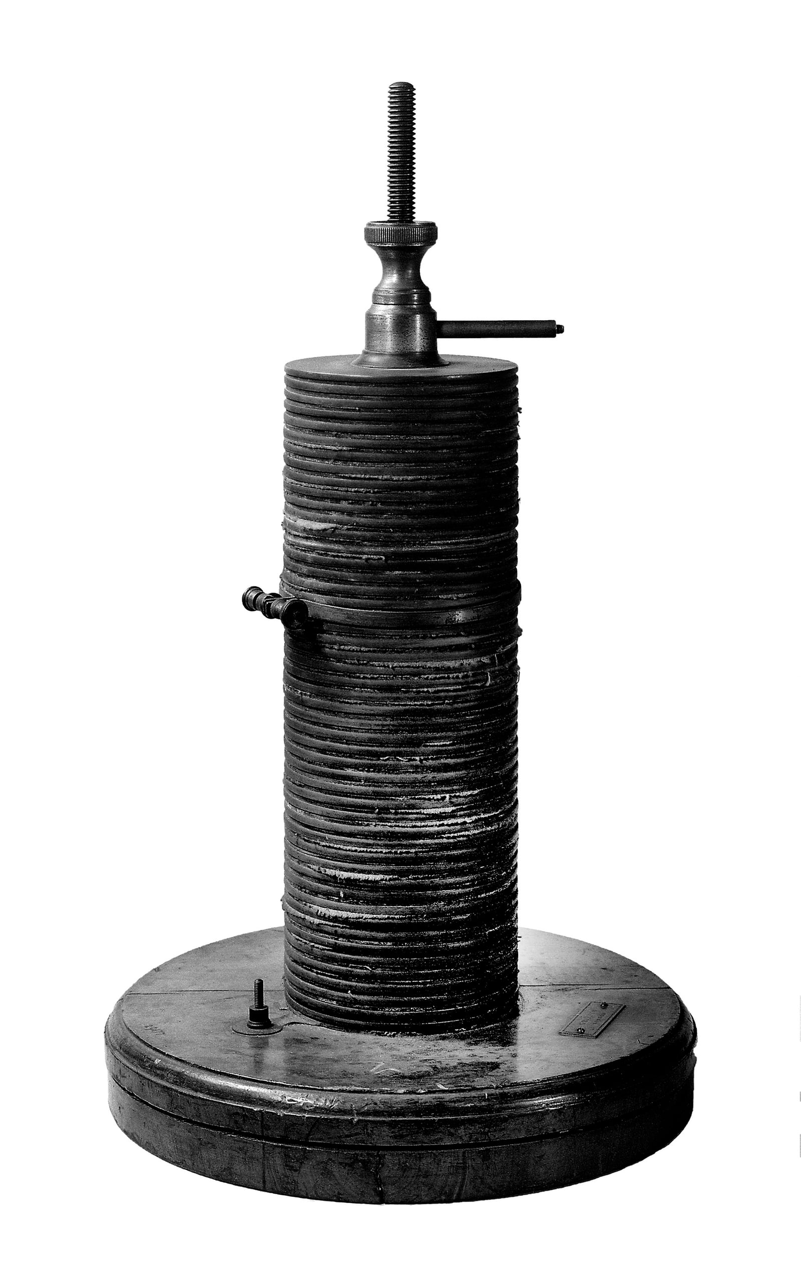 Figure 3 — A large voltaic pile by Griffin of London: the stack of alternating discs with their moist separators, clamped on a turned base with a terminal at the top. The Leyden jar could only store and dump …