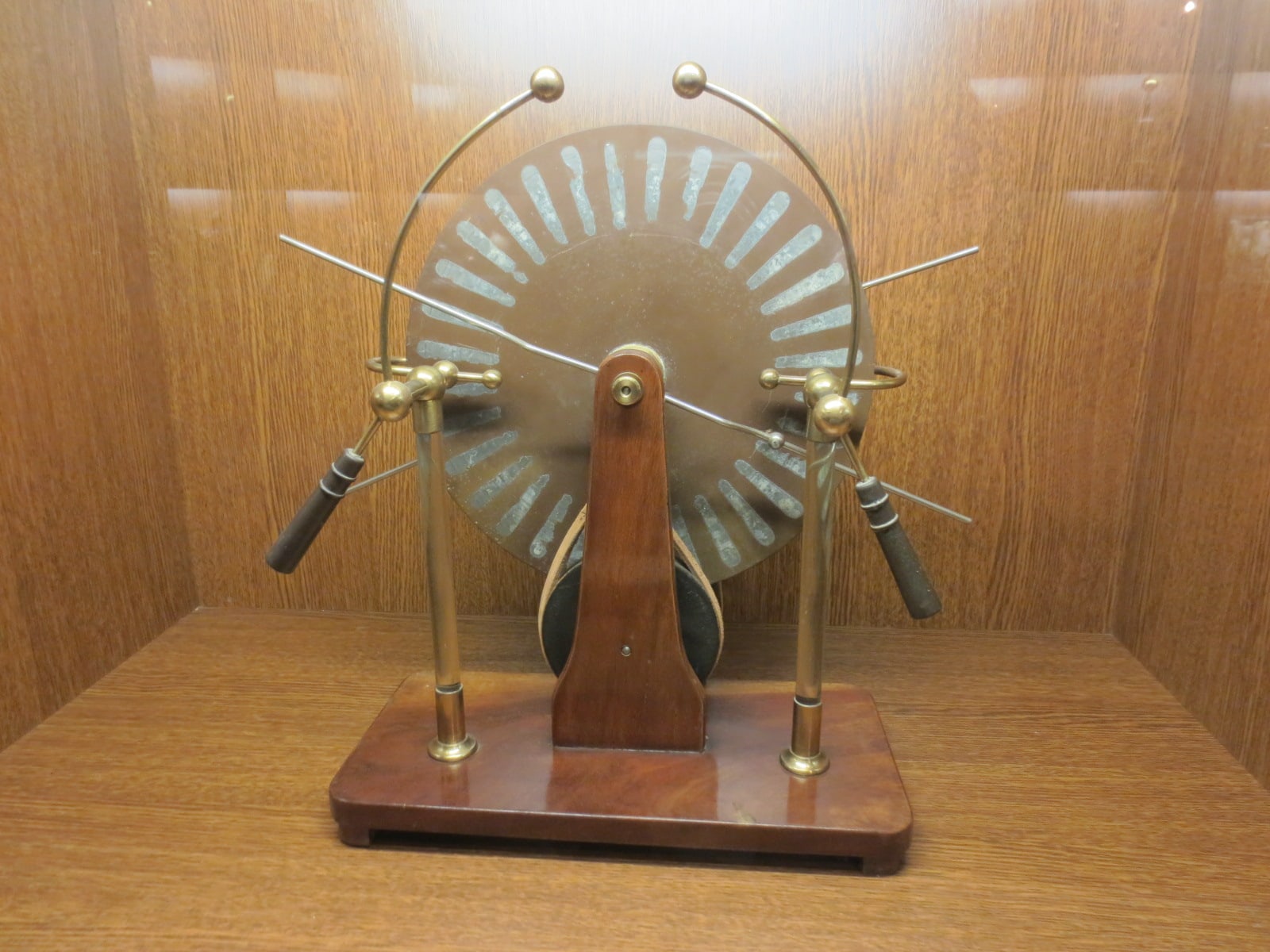 Figure 3 — A Wimshurst influence machine as a collector meets one: contra-rotating discs carrying their metal sectors, the brass collecting combs on their standards, the spark gap between the ball terminals, …