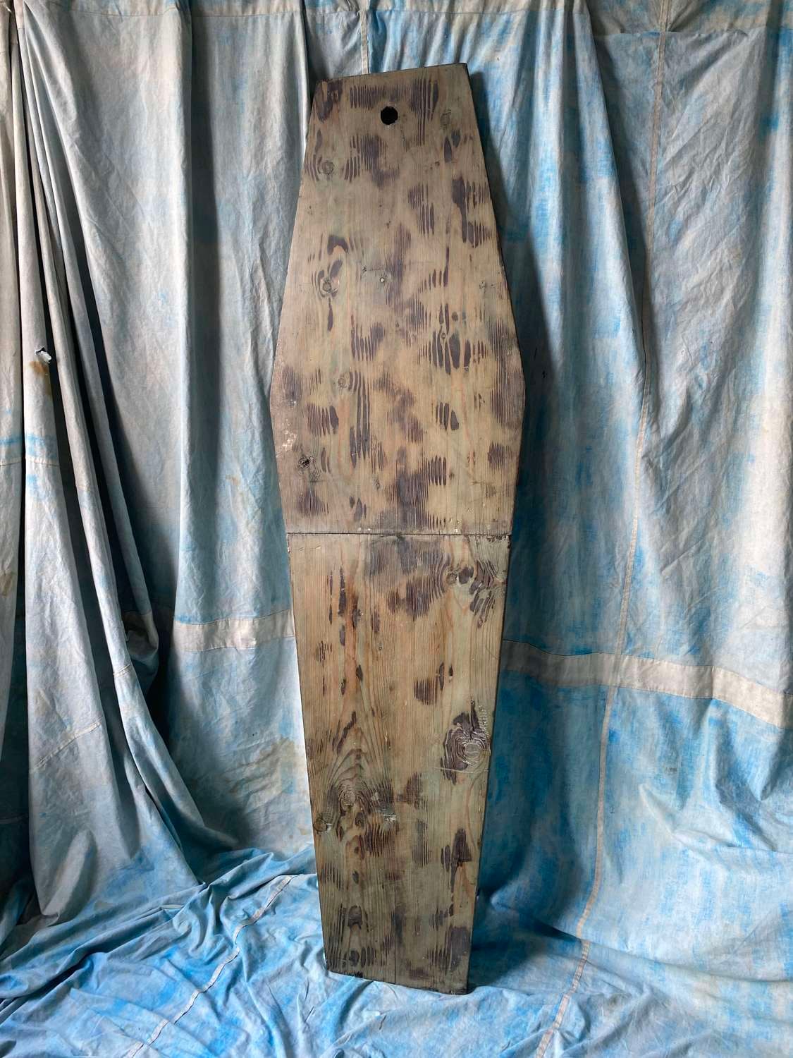 Figure 1 — A surviving Victorian undertaker's cooling board — a single coffin-shaped plank, tapered at both ends, with a hanging hole bored at the head. No mechanism, no plumbing, no maker's plate: this is th…
