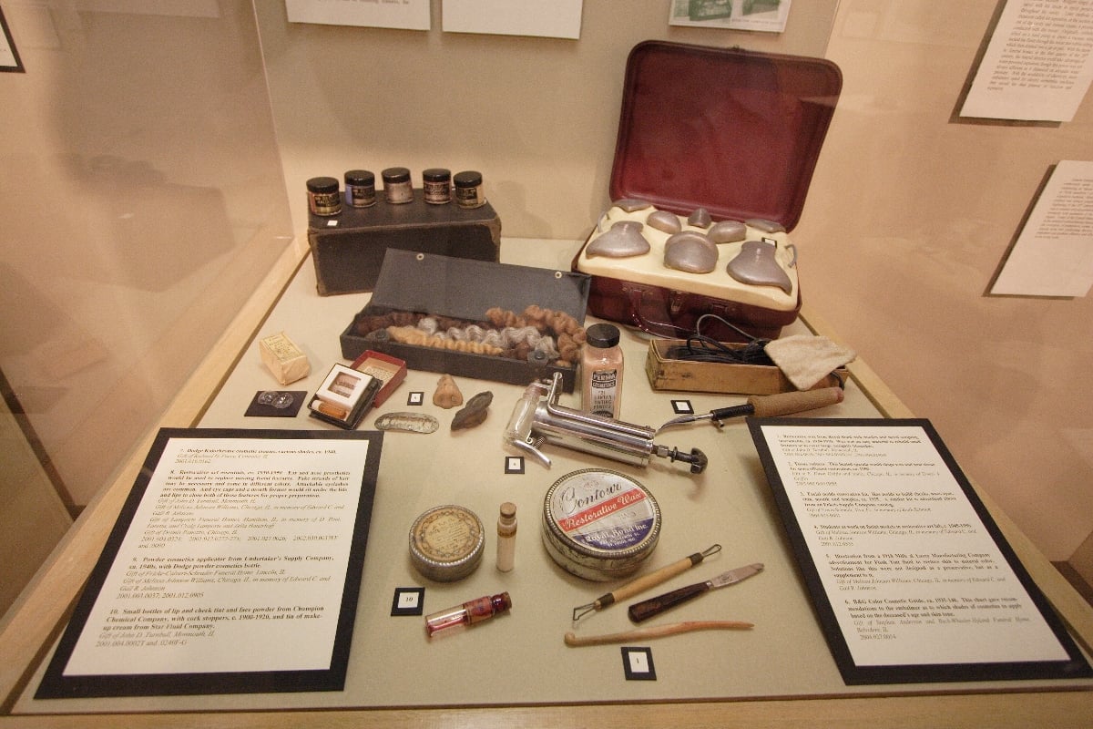 Figure 1 — How the material is properly shown: a cased instrument set opened flat in a museum vitrine, with interpretive panels either side doing the explaining. Apparatus, documentation, and no spectacle — t…