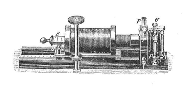 Figure 2 — The working core of the box: the iron-cored induction coil with its sliding secondary (the faradic intensity control) and, beside it, the vibrating make-and-break interrupter — the "rheotome" — tha…