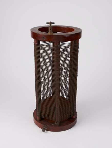 Figure 2 — A detached Oudin resonator coil: heavy copper wire space-wound on a mahogany frame between two ring ends — the component most often found and sold on its own, and the one that most clearly marks an…