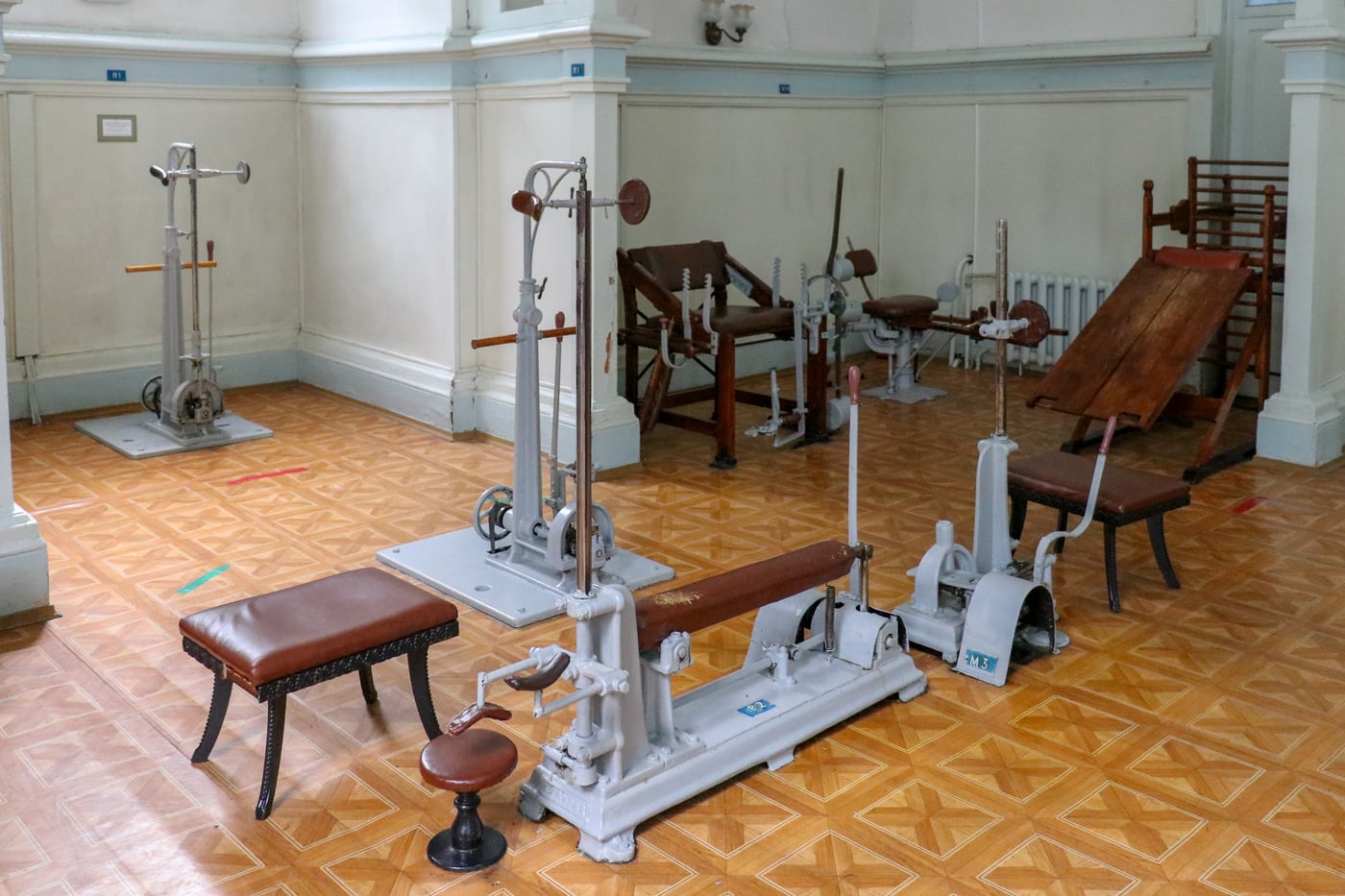 Figure 2 — A single Zander resistance machine: the patient's seat, the working lever, and the sliding weight on a graduated arm that sets the resistance — the mechanism that let a measured "dose" of exercise …