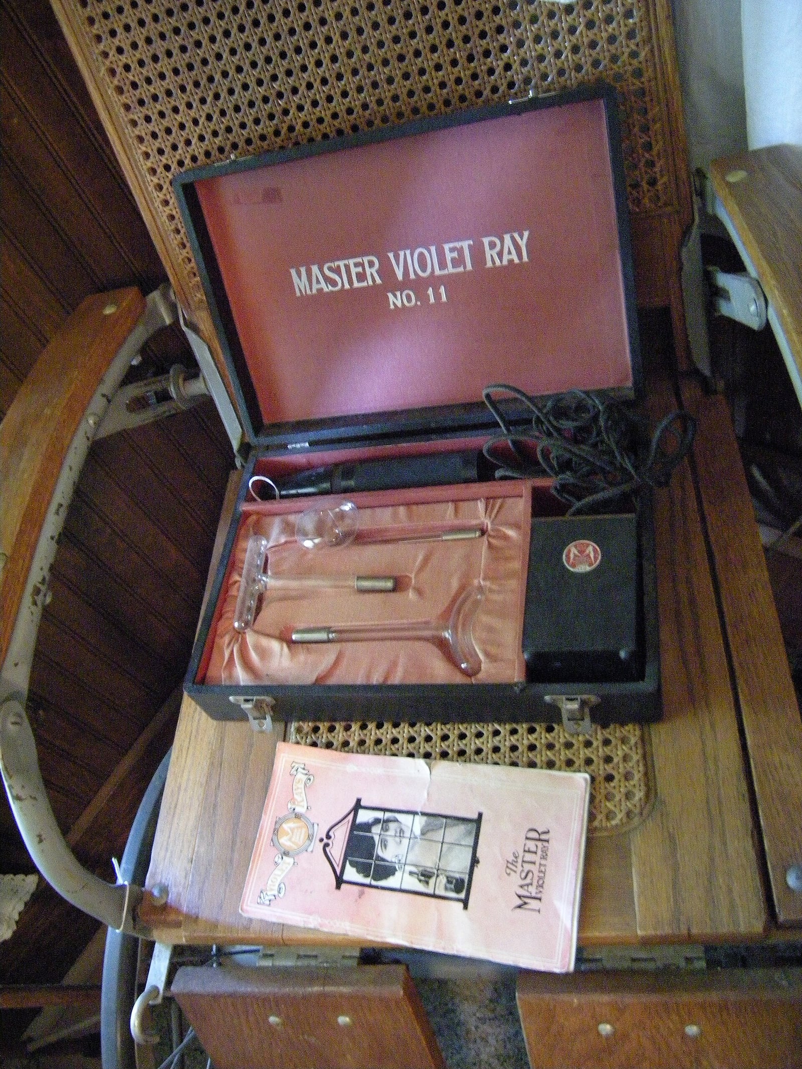 Figure 2 — A "Master Violet Ray No. 11" as it survives today, with its instruction booklet still in the lid. Dozens of makers sold near-identical outfits under confident names; the booklet, not the physics, i…