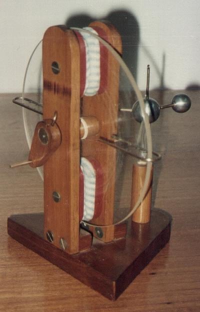 Figure 2 — An eighteenth-century frictional plate machine of the Ramsden type: a hand-cranked glass disc turned between leather rubbing pads, with a brass prime conductor to collect the charge.