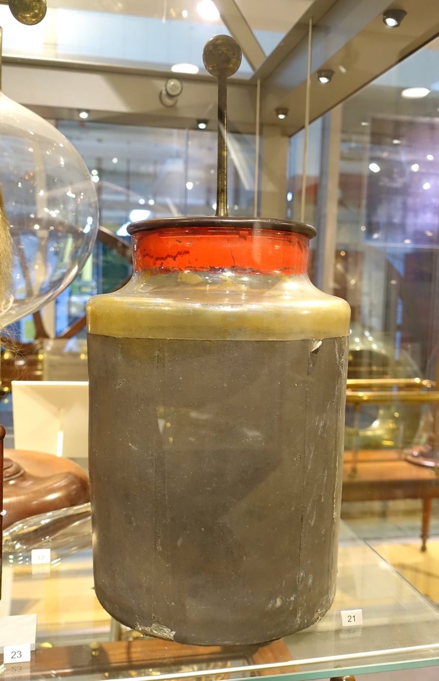 Figure 4 — Detail of a Leyden-jar condenser from an influence machine: a glass jar lined inside and out with metal foil, the earliest practical capacitor, used to store the machine's charge and sharpen its di…