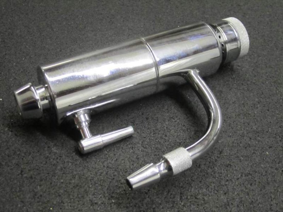 Figure 3 — A funeral-supply trade-catalog plate offering a hydro-aspirator with its faucet coupling and hose, listed beside trocars as a matched cavity-treatment outfit.